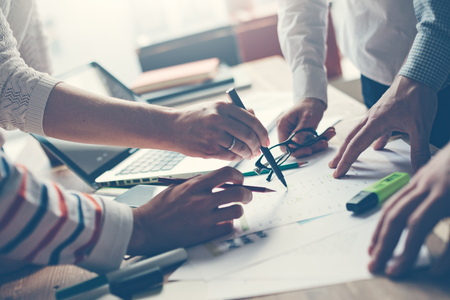 Team meeting. Discussing new project. Laptop and paperwork in office. Pale coloursの写真素材