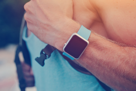 Man with backpack wearing smart watch on the wristの写真素材