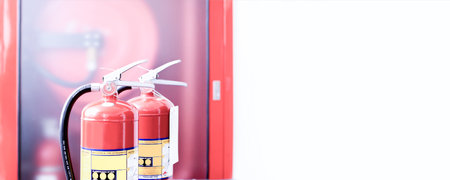 The red fire extinguisher is ready for use in case of an indoor fire emergency.の写真素材