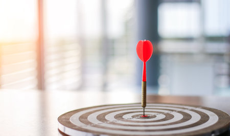 dart board has dart arrow throw hitting the center of a shooting target for business targeting and winning goals business concepts.の写真素材