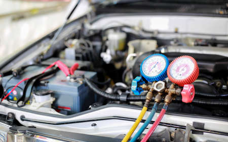 Car air conditioner check service, leak detection, fill refrigerant.Device and meter liquid cooling in the car by specialist technicians.の写真素材
