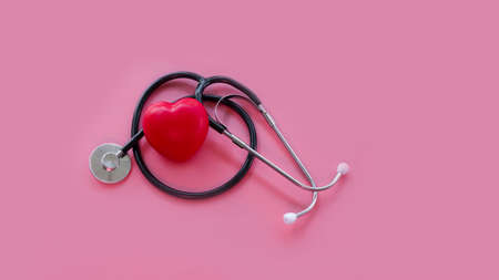 Stethoscope and red hearts on a pink background, Health care concept.の写真素材
