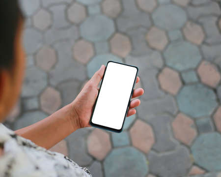 A smartphone with a creative white screen and a field of electric wind turbines in the background.