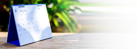 White desk calendar on a wooden table, planning ideas.の写真素材