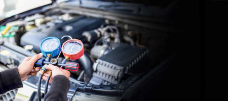 Car air conditioner check service, leak detection, fill refrigerant.Device and meter liquid cooling in the car by specialist technicians.の写真素材