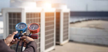 technician checks the operation of the air conditioner.の写真素材
