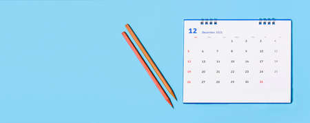 white desk calendar on blue background, planning conceptの写真素材