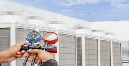 Air conditioner technician checking air conditioner operationの写真素材