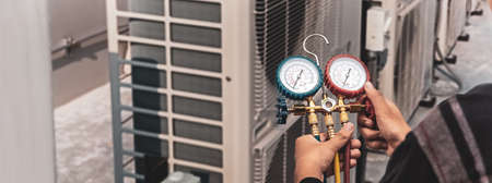 Air conditioner technician checks the operation of industrial air conditioners.の写真素材