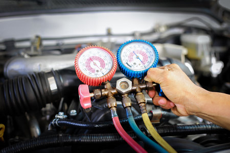 Car air conditioner check service, leak detection, fill refrigerant.Device and meter liquid cooling in the car by specialist technicians.の写真素材