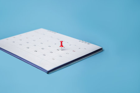 white desk calendar on blue backgroundの写真素材
