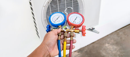 technician checks the operation of the air conditioner.の写真素材