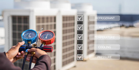 The technician checks the operation of the air conditioner according to the checklist.の写真素材
