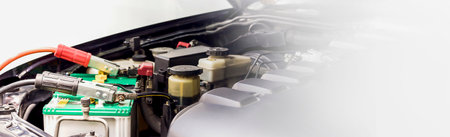 Close up Charging car battery with electricity through jumper cables.の写真素材