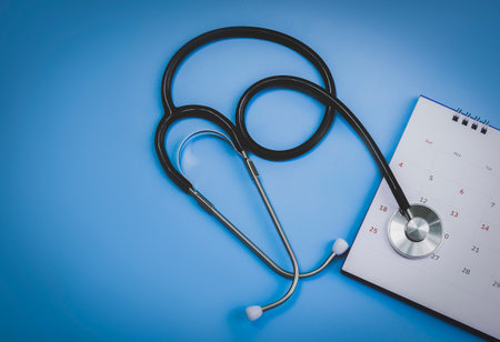 Calendar, stethoscope, on a blue background, health care concept.の写真素材