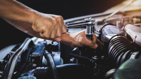 Car mechanic working on car engine, car maintenance concept.の写真素材
