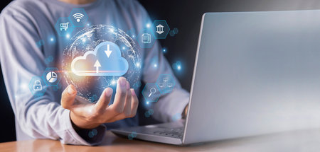 Cloud computing technology and online data storage. Businessman using laptop computer with cloud...