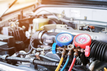 Car air conditioner check service, leak detection, fill refrigerant.Device and meter liquid cooling in the car by specialist technicians.の写真素材