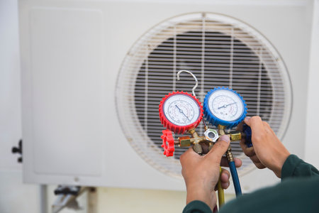 Technician is checking air conditioner ,measuring equipment for filling air conditioners.の写真素材