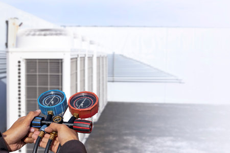Air conditioner technician checking air conditioner operationの写真素材