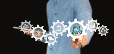 carbon neutral concept net zero icon and on hand for net zero emissions target Weather neutral long term strategy on green background.の写真素材