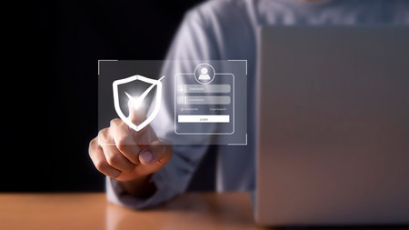 Man using laptop computer with security shield icon on screen 3D renderingの写真素材