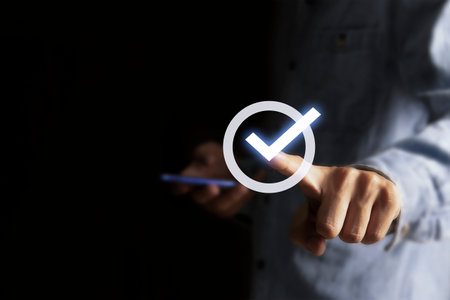 Checklist concept. Businessman is marking checkboxes.の写真素材