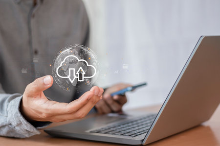 Cloud computing technology concept. Businessman working with laptop computer and cloud icon on...