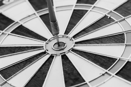 Dart hitting the center of the dartboard business target conceptの写真素材