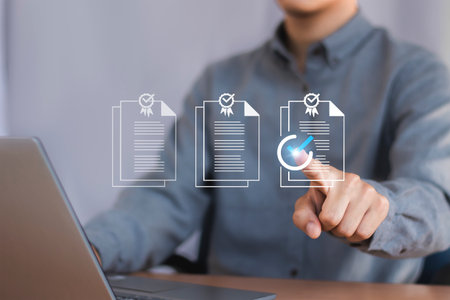 Businessman hand pointing at document with checklist icon on virtual screen.の写真素材