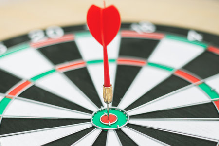 Dartboard with dart arrow in the center, business target concept