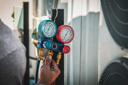 Man checking the pressure of the air conditioner with a thermometerの写真素材