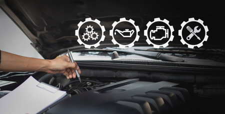 Auto mechanic checks engine repair list service conceptの写真素材