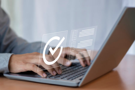 Digital document approval checklist on laptop screen. Productivity and business technology concept. Document validity management and online surveys. Enterprise business technology.の写真素材