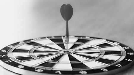 Darts arrows hitting the center of dartboard, business success conceptの写真素材