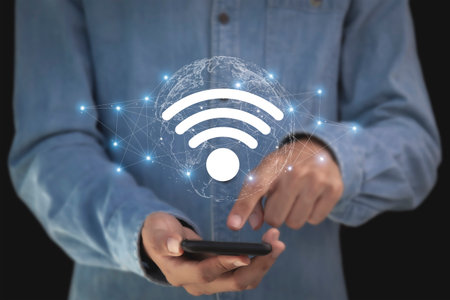 Man holding mobile phone with wifi icon on the screen, connection concept