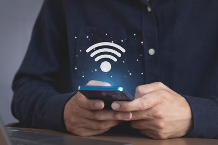 Man using smart phone with wifi icon on the screen, internet connection concept