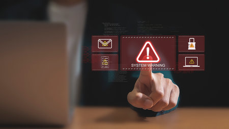 Cybersecurity Alert A Hand Holding a Holographic Warningの写真素材
