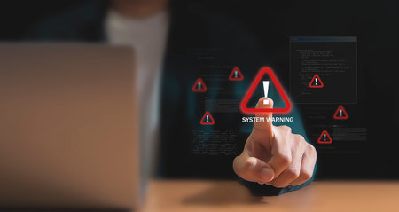 Cybersecurity Alert A Hand Holding a Holographic Warningの写真素材