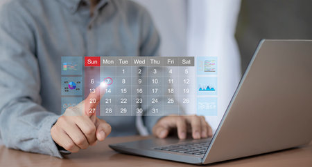 businessman working on laptop computer in modern office with virtual screen interfaceの写真素材