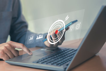 Businessman using laptop computer with target icon on screen. Business and technology concept.の写真素材