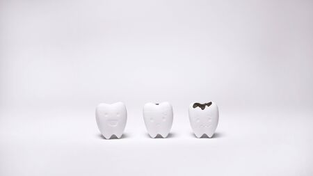 Healthy Tooth and Decayed Tooth Model on White Background