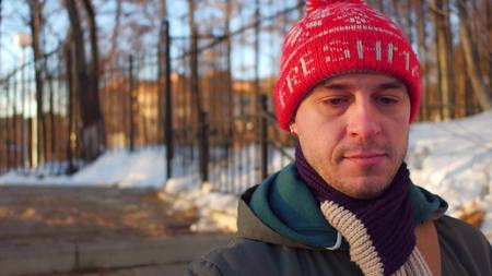 Pensive man in red hat walking in the parkの写真素材