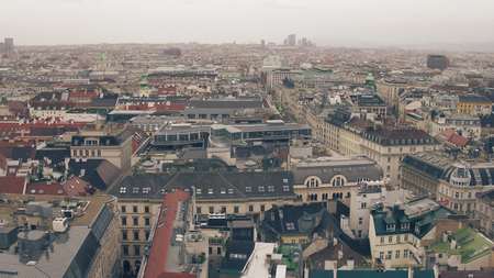 Old and modern buildings roofs in Vienna on a cloudy day, Austria. Warm colorsの写真素材