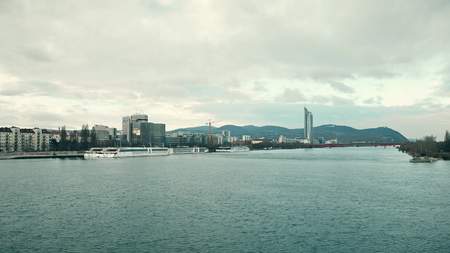 VIENNA, AUSTRIA - DECEMBER, 25 Danube river, touristic boats and distant Pensionsversicherungsanstalt officeのeditorial素材