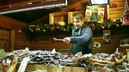PARIS, FRANCE - DECEMBER, 31. Christmas and New Year market food stall vendor. Traditional sausages, meatのeditorial素材