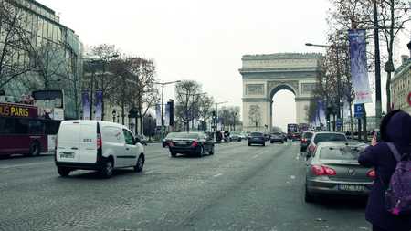 PARIS, FRANCE - DECEMBER, 1, 2017. Champs-Elysees street and famous triumphal arch, Arc de Triomphe. Woman making photo with her mobile phoneのeditorial素材