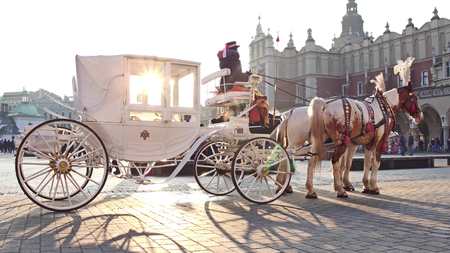 KRAKOW, POLAND - JANUARY, 14, 2017 Retro horse drawn carriage and touristic streetのeditorial素材