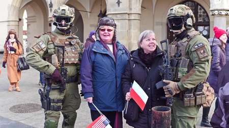 KRAKOW, POLAND - JANUARY, 14, 2017 Armed special force soldiers posing with civilians holding Polish and American flags at WOSP military showのeditorial素材