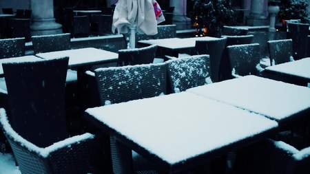 Street cafe tables in the snow. Low season conceptの写真素材